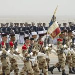 Soldiers from the French Military carry the flag of the French Republic’s 11 regiment during a military parade in Subiya, Kuwait