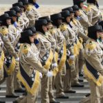 Female police offices march during a military parade in Subiya, Kuwait