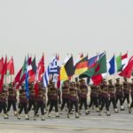 Kuwaiti soldiers carry the flags of Coalition Forces in Subiya during a military parade in Subiya, Kuwait