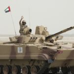 A soldier from the United Arab Emirate waves to the crowd during a military parade in Subiya, Kuwait